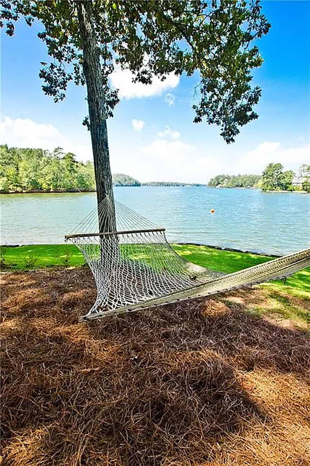 rustic lake house exterior landscaping with a hammock