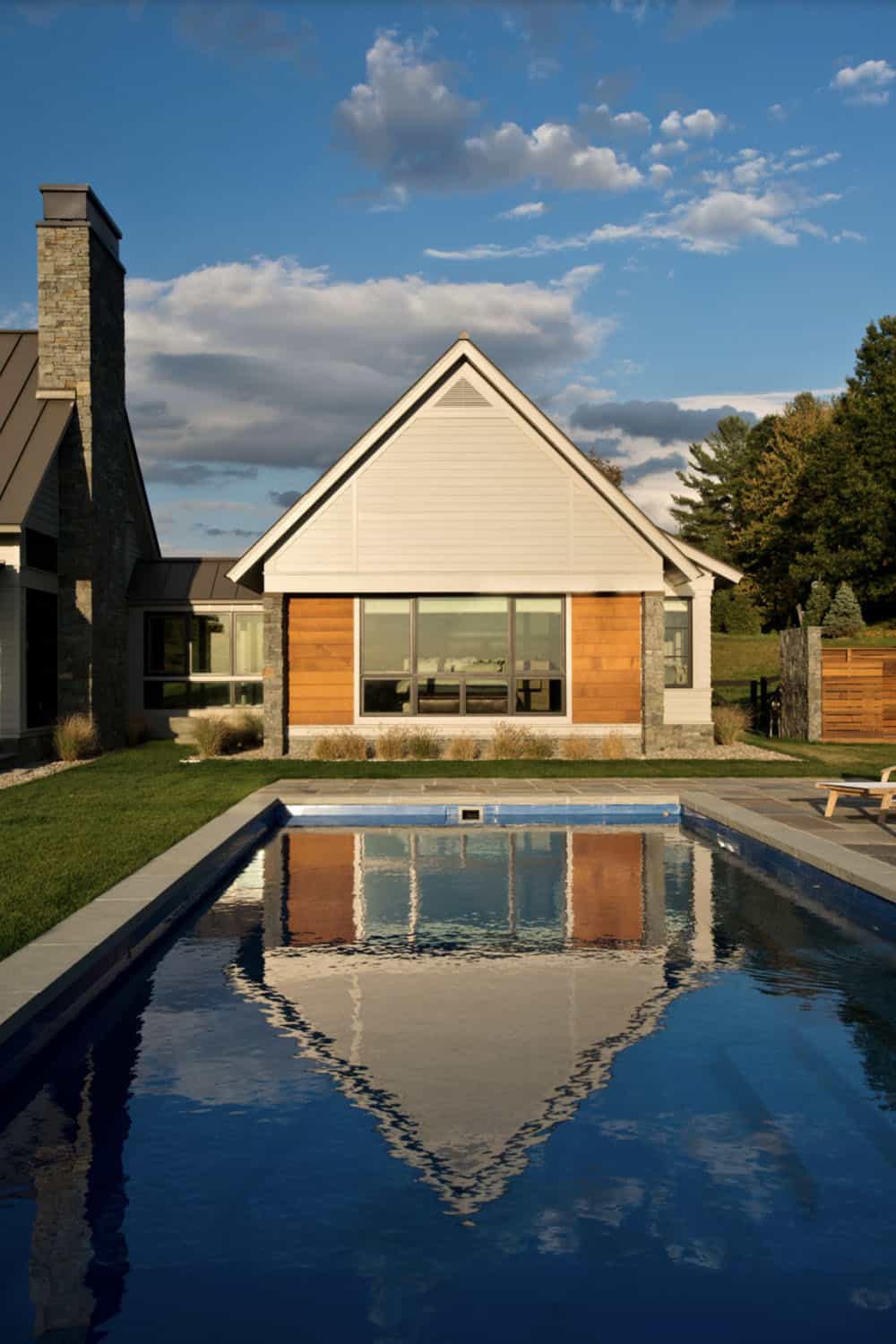modern farmhouse exterior with a pool