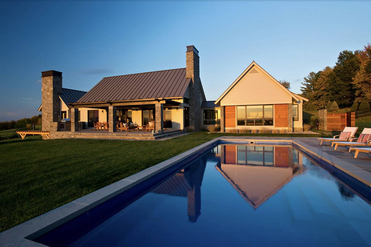 modern farmhouse exterior with a pool