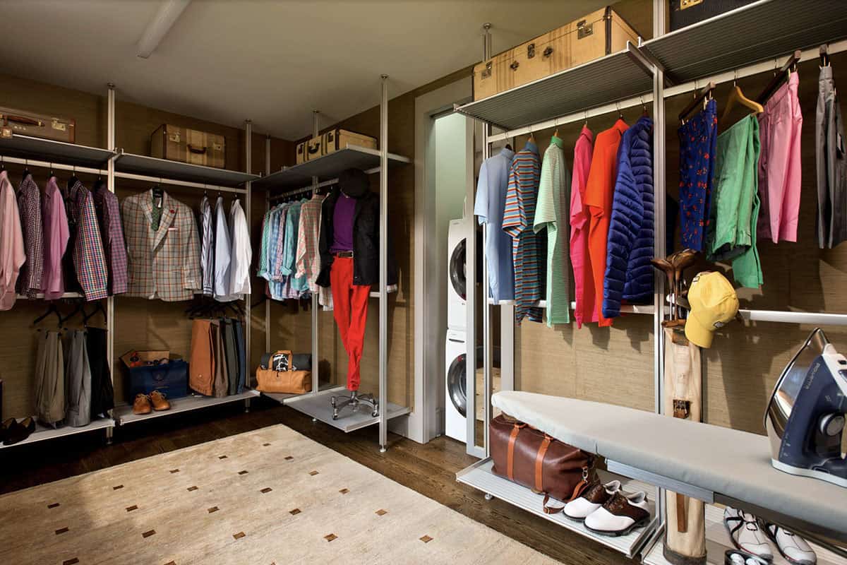 modern farmhouse style walk-in closet with a stackable washer and dryer