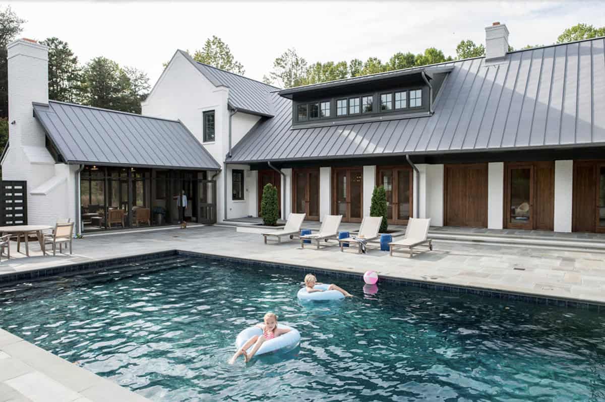 modern farmhouse home exterior backyard with a pool
