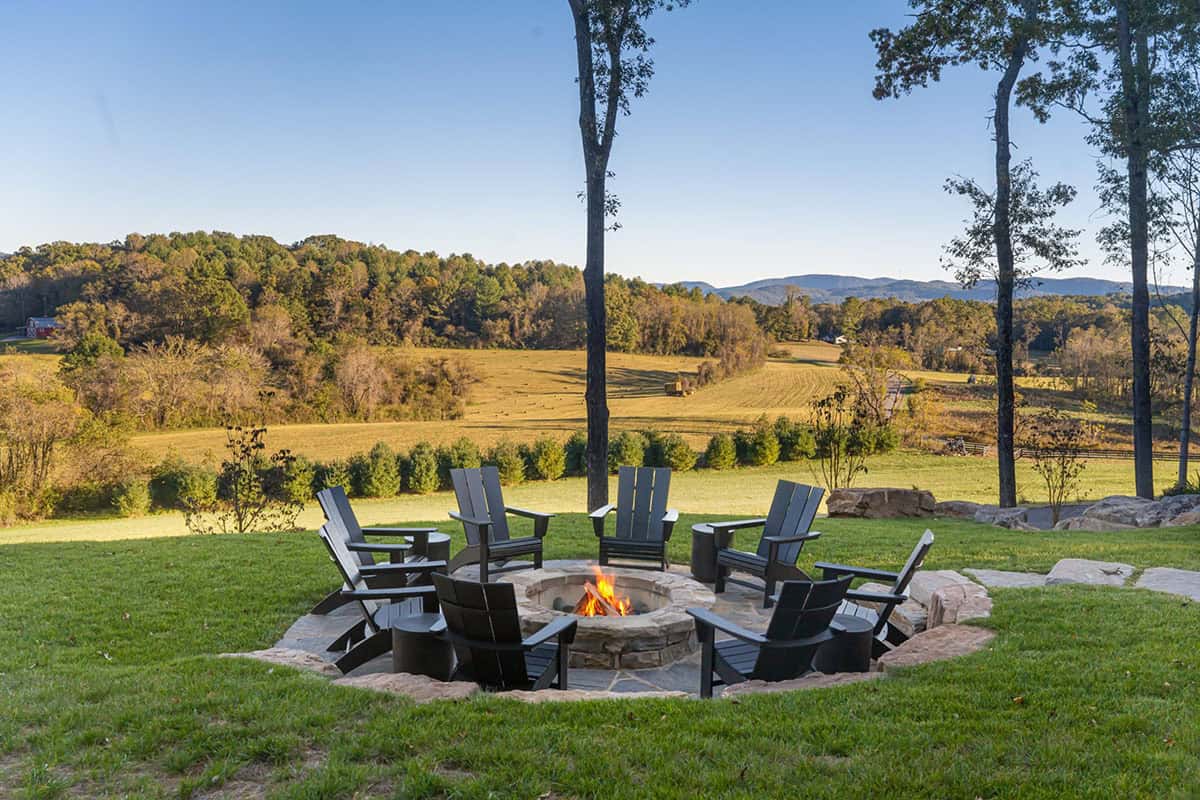 mountain home exterior backyard fire pit with adirondack chairs
