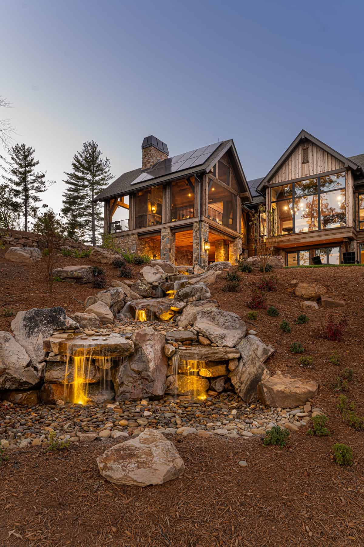 mountain home exterior backyard with a waterfall feature
