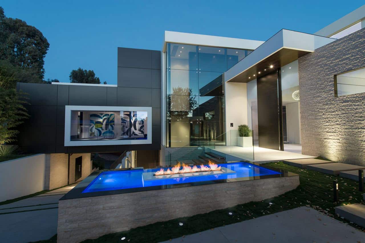 modern home exterior with a pool and fireplace
