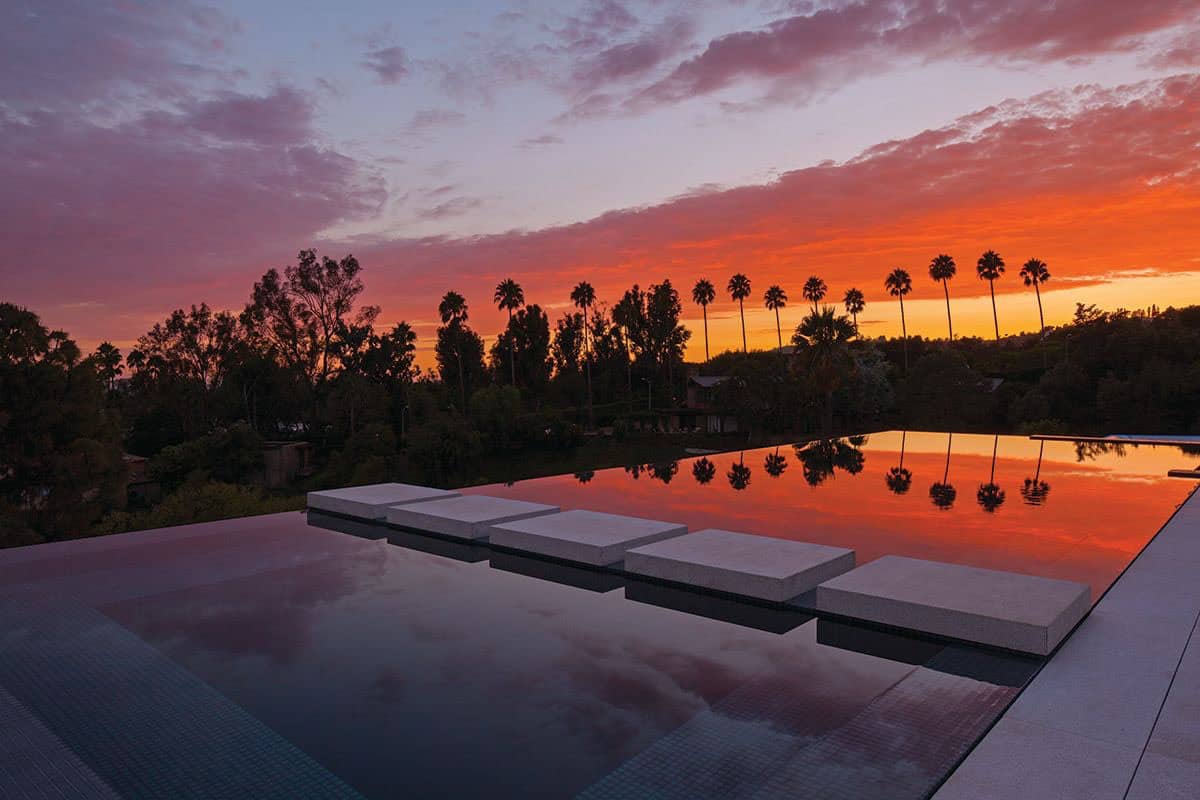 modern home exterior patio and pool at sunset