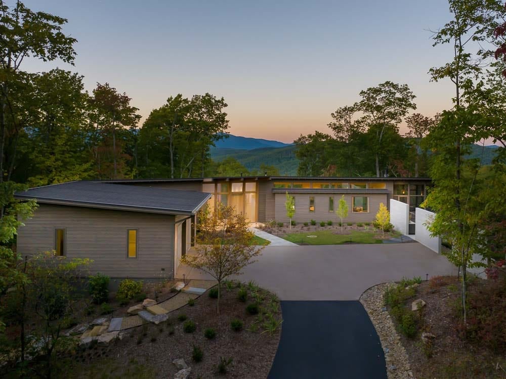 modern mountain home exterior at dusk
