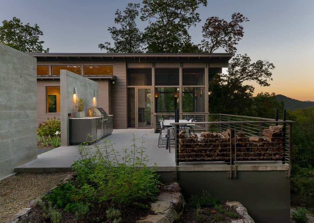 modern mountain home exterior backyard patio with a grill
