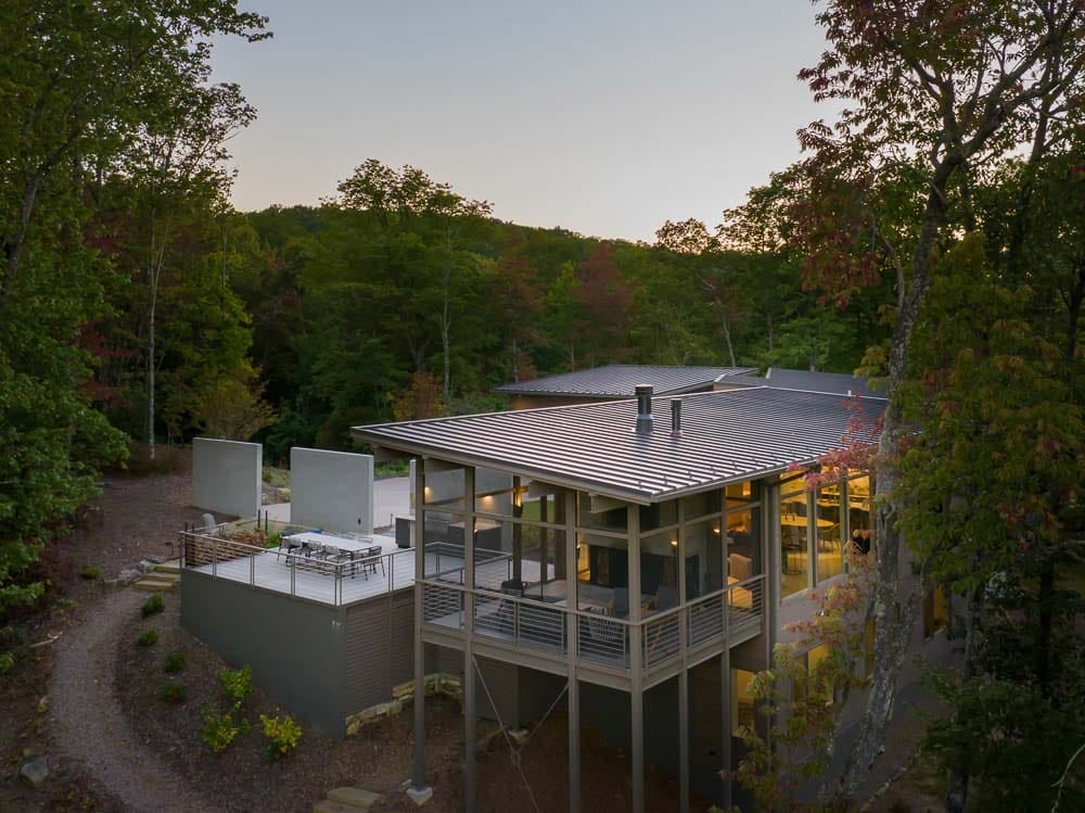 modern mountain home exterior aerial view at dusk