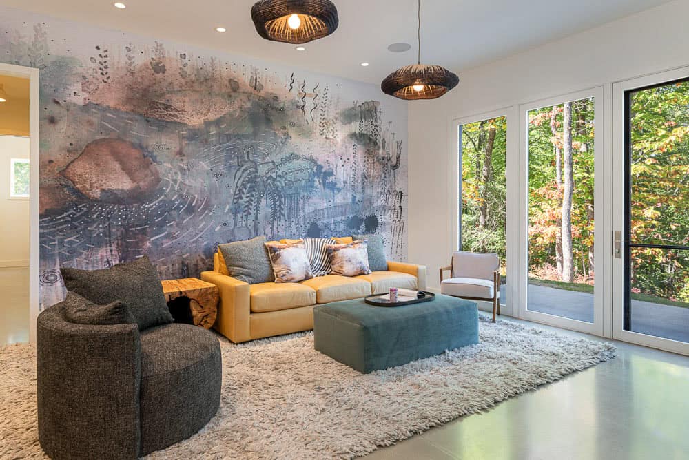 modern basement level family room with an art mural wall