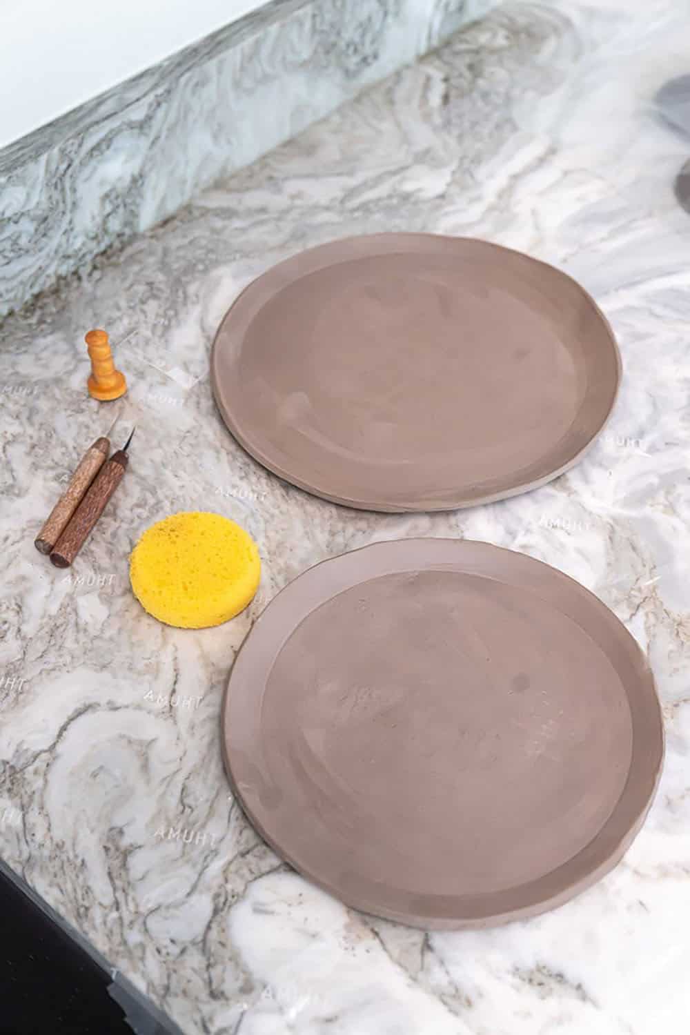 modern basement level art room countertop with potter plates in-process