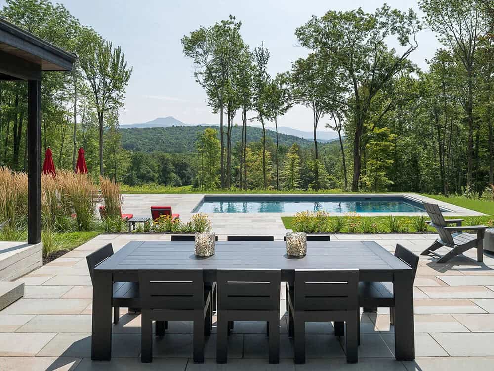 modern rustic home exterior with a patio and alfresco dining