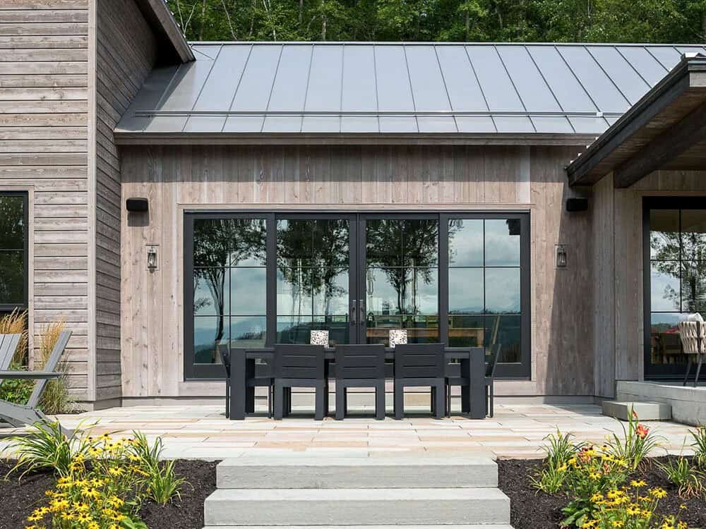 modern rustic home exterior with a patio and alfresco dining