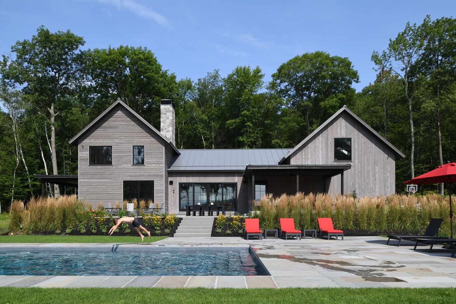 modern rustic home exterior with a pool