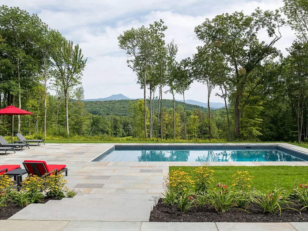 modern rustic home exterior with a pool