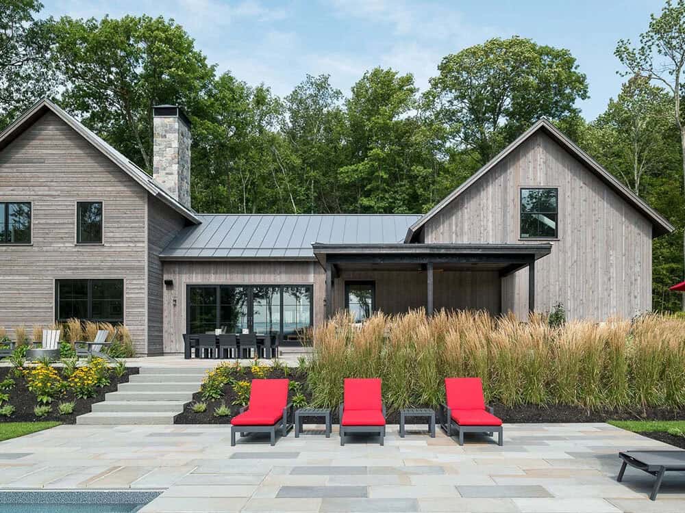 modern rustic home exterior with a patio and pool