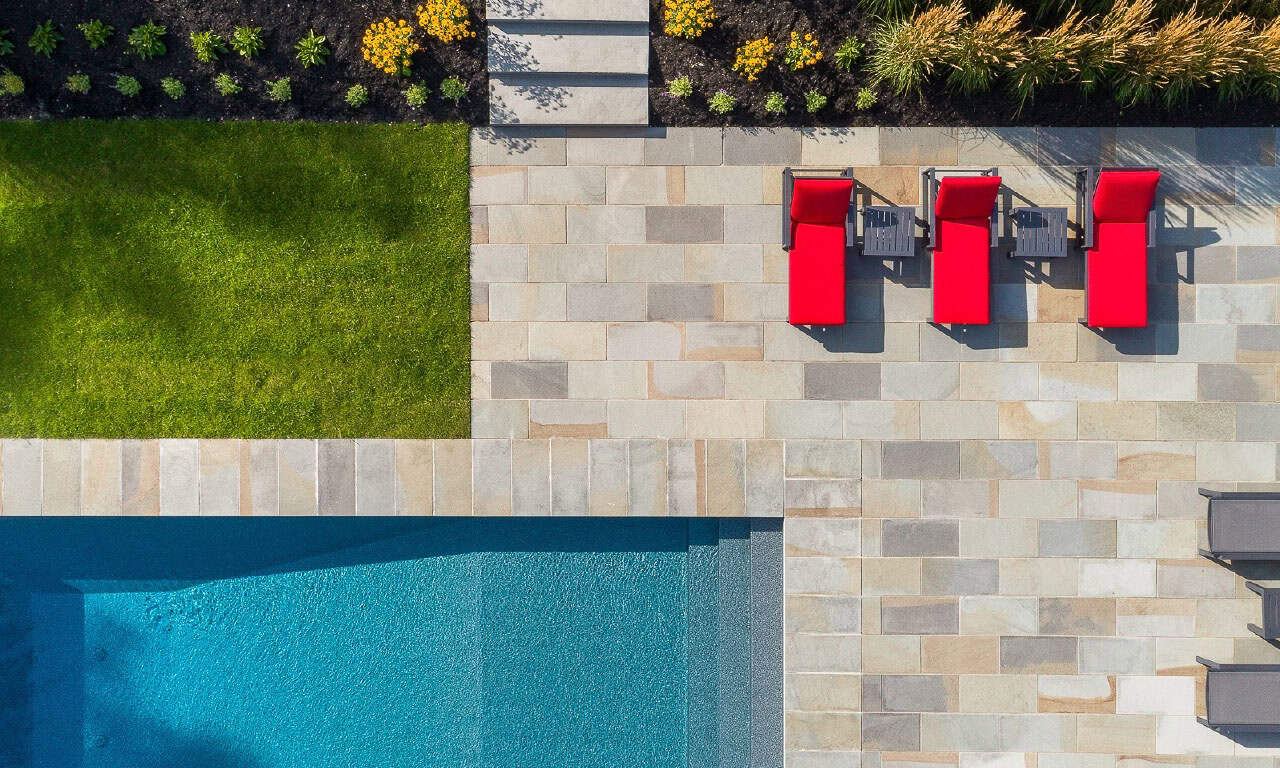 modern rustic home exterior with a pool aerial view