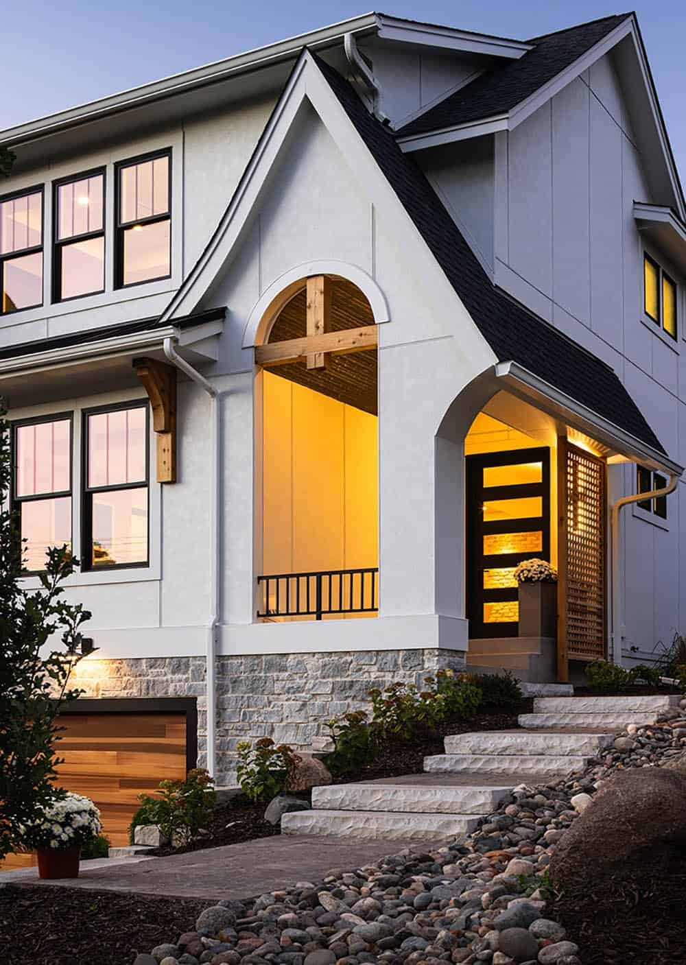 modern tudor style home exterior at dusk