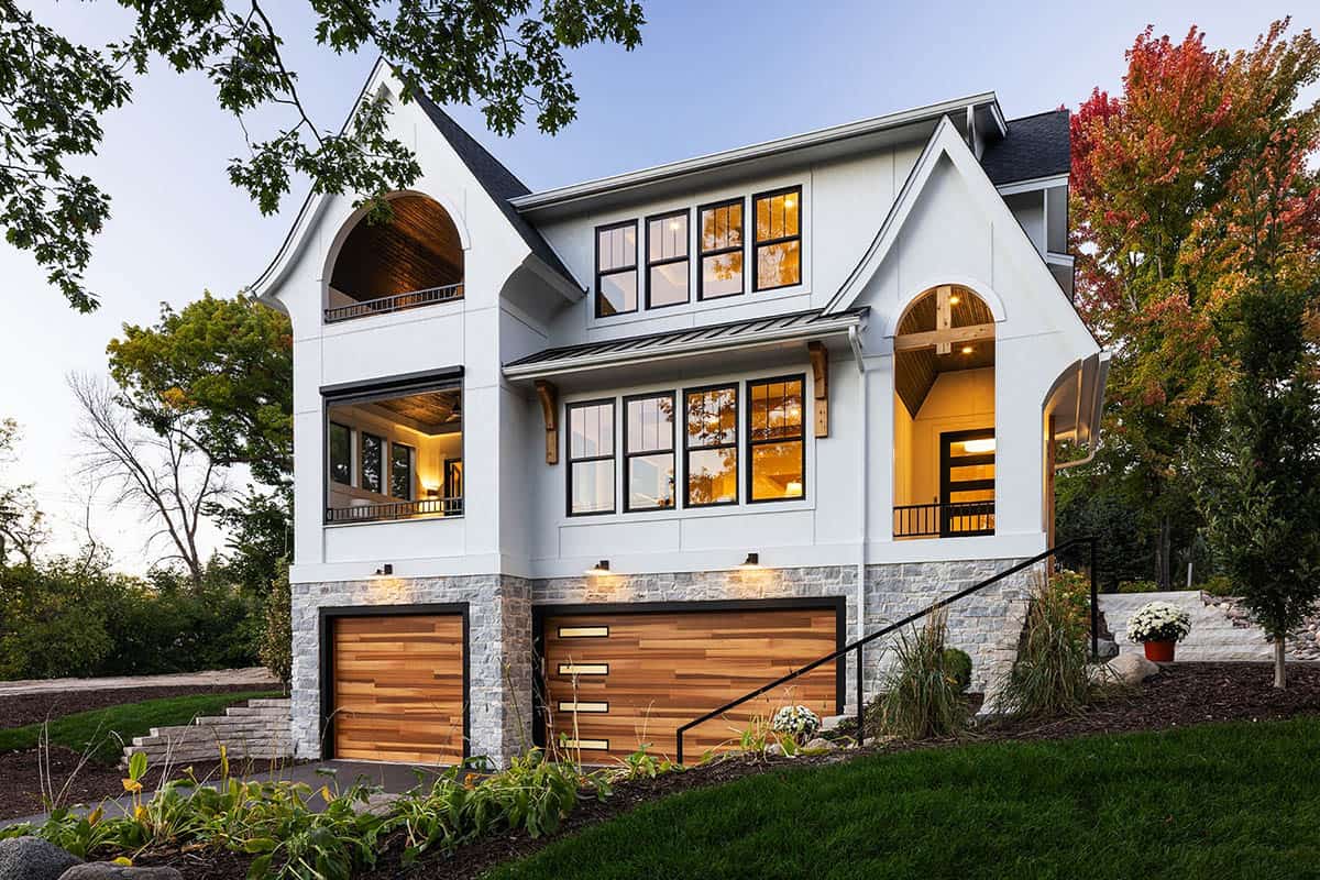 modern tudor style home exterior at dusk