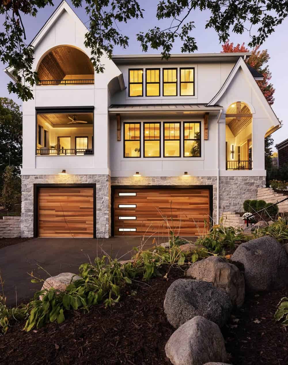 modern tudor style home exterior at dusk