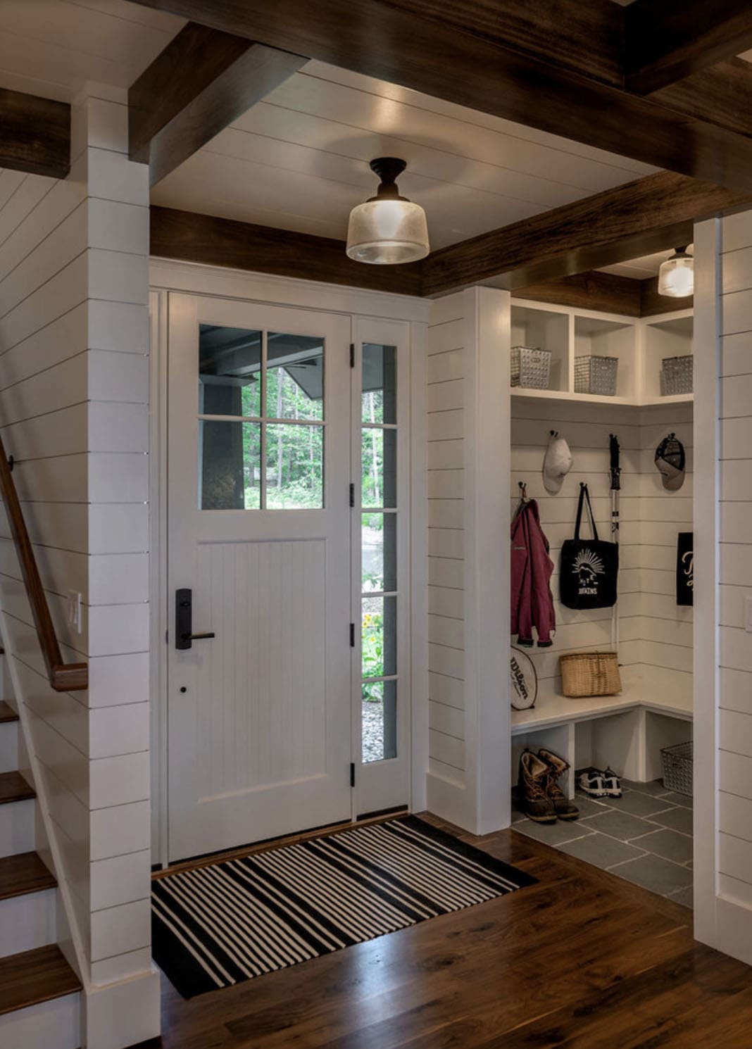 Craftsman home entry with a built-in bench and storage cubbies