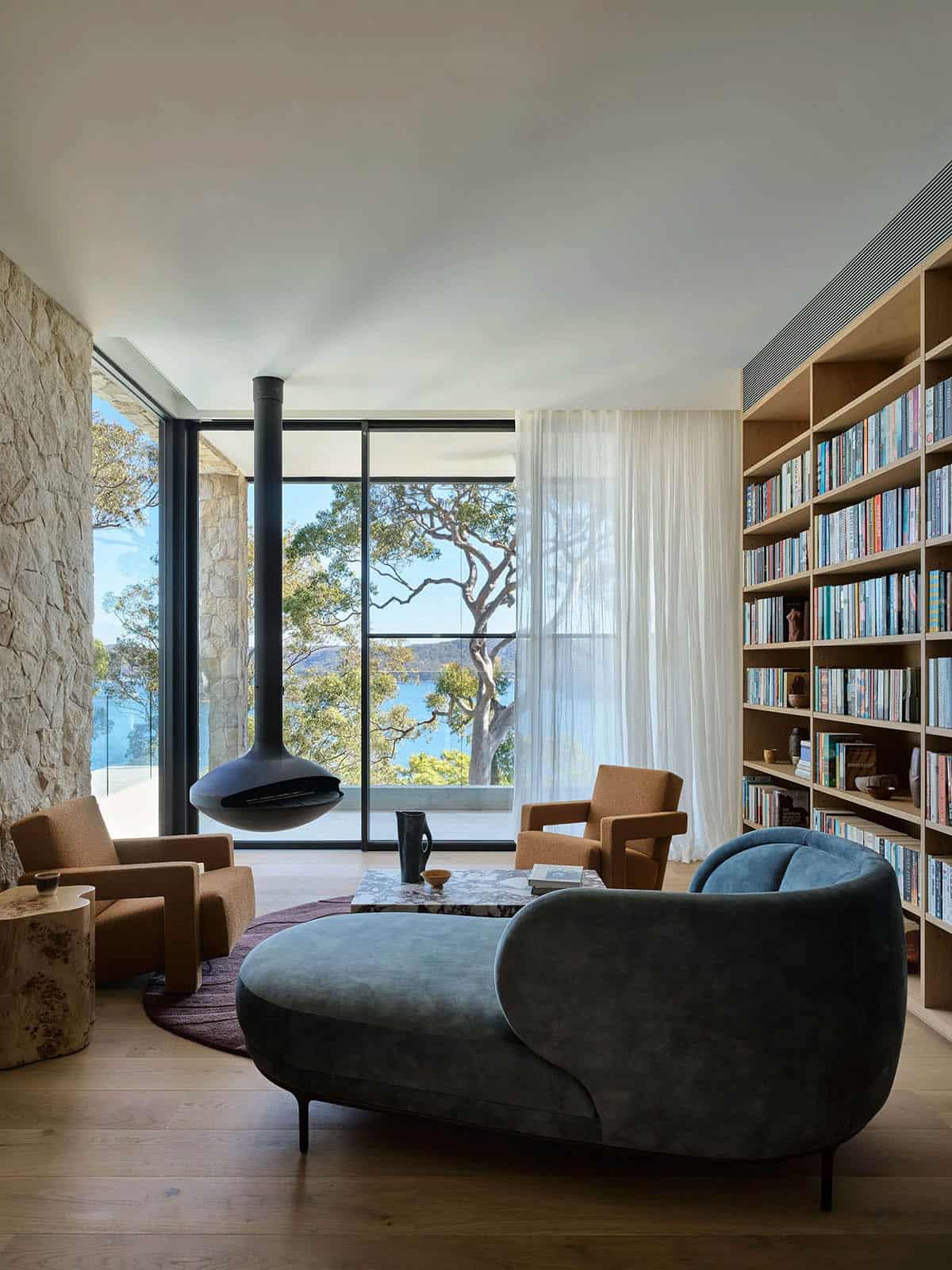 A modern living room with bookshelves and a large window.