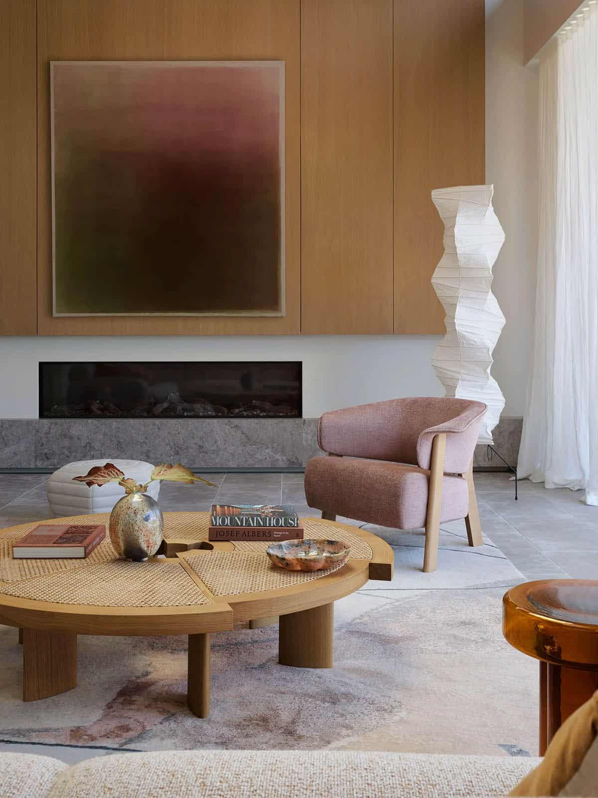 A table with a vase of flowers and a plate.