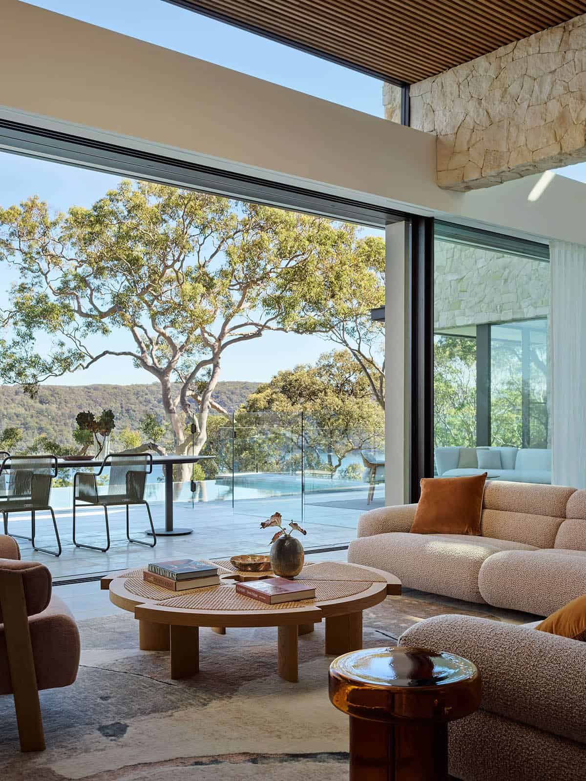 living room with a large glass wall overlooking the water