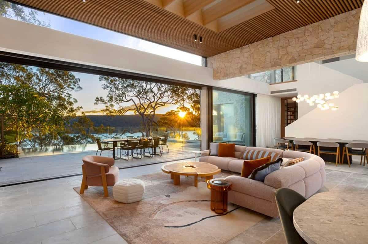 living room with a large glass wall overlooking the water