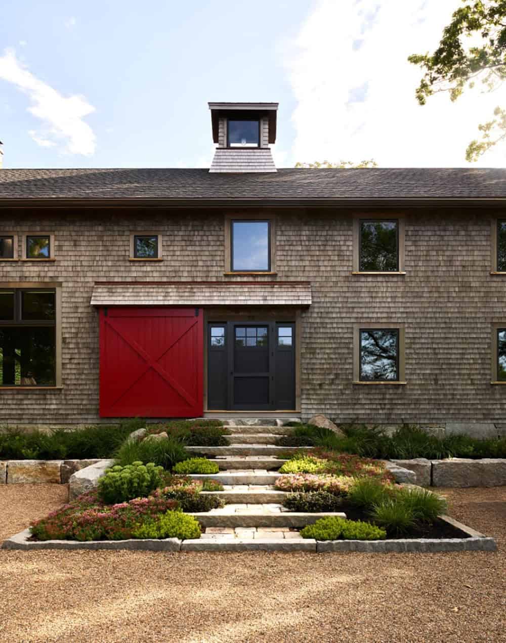 rustic modern barn house exterior with a red door