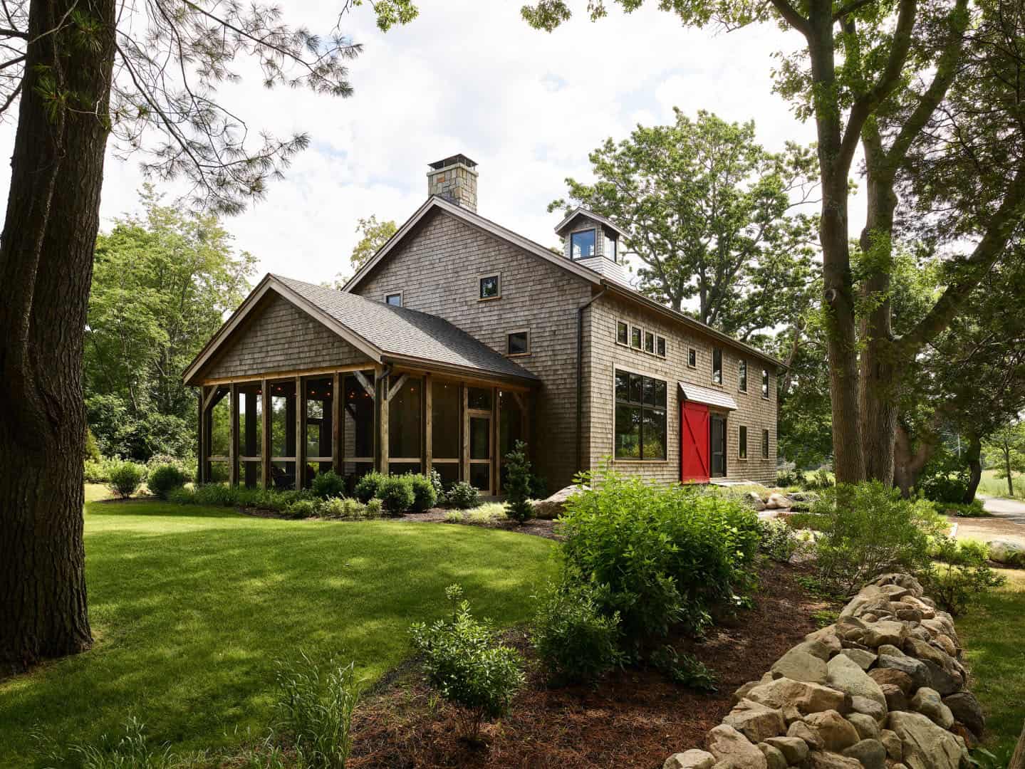 rustic modern barn house exterior with a red door