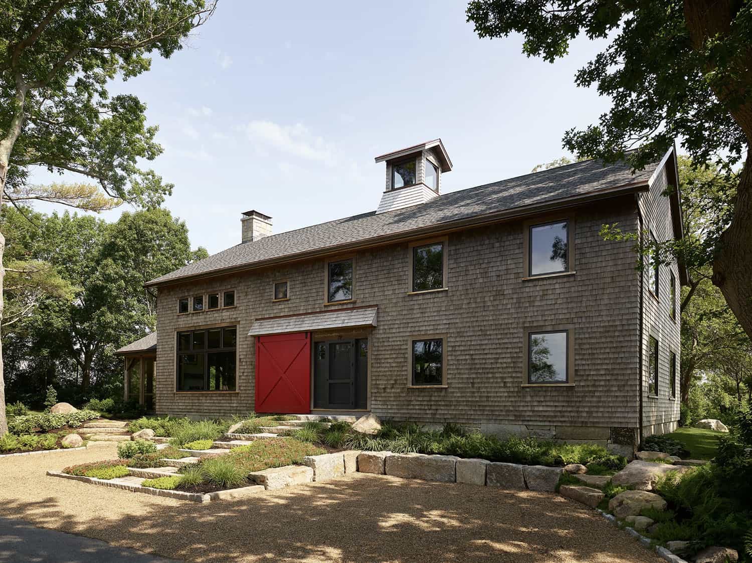 rustic modern barn house exterior with a red door
