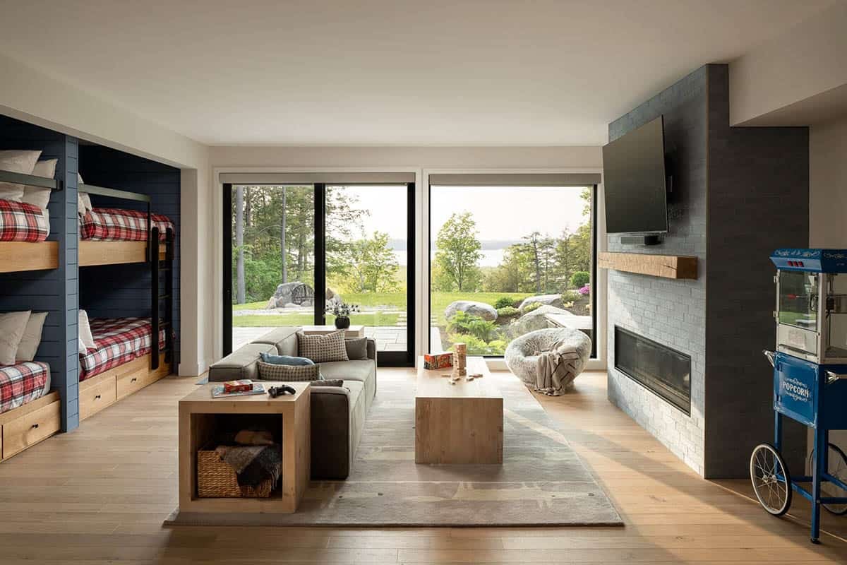 modern bunk room with a sitting area and fireplace