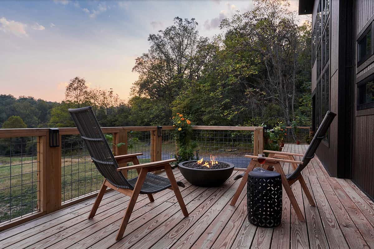 deck with a cozy fire pit and two chairs