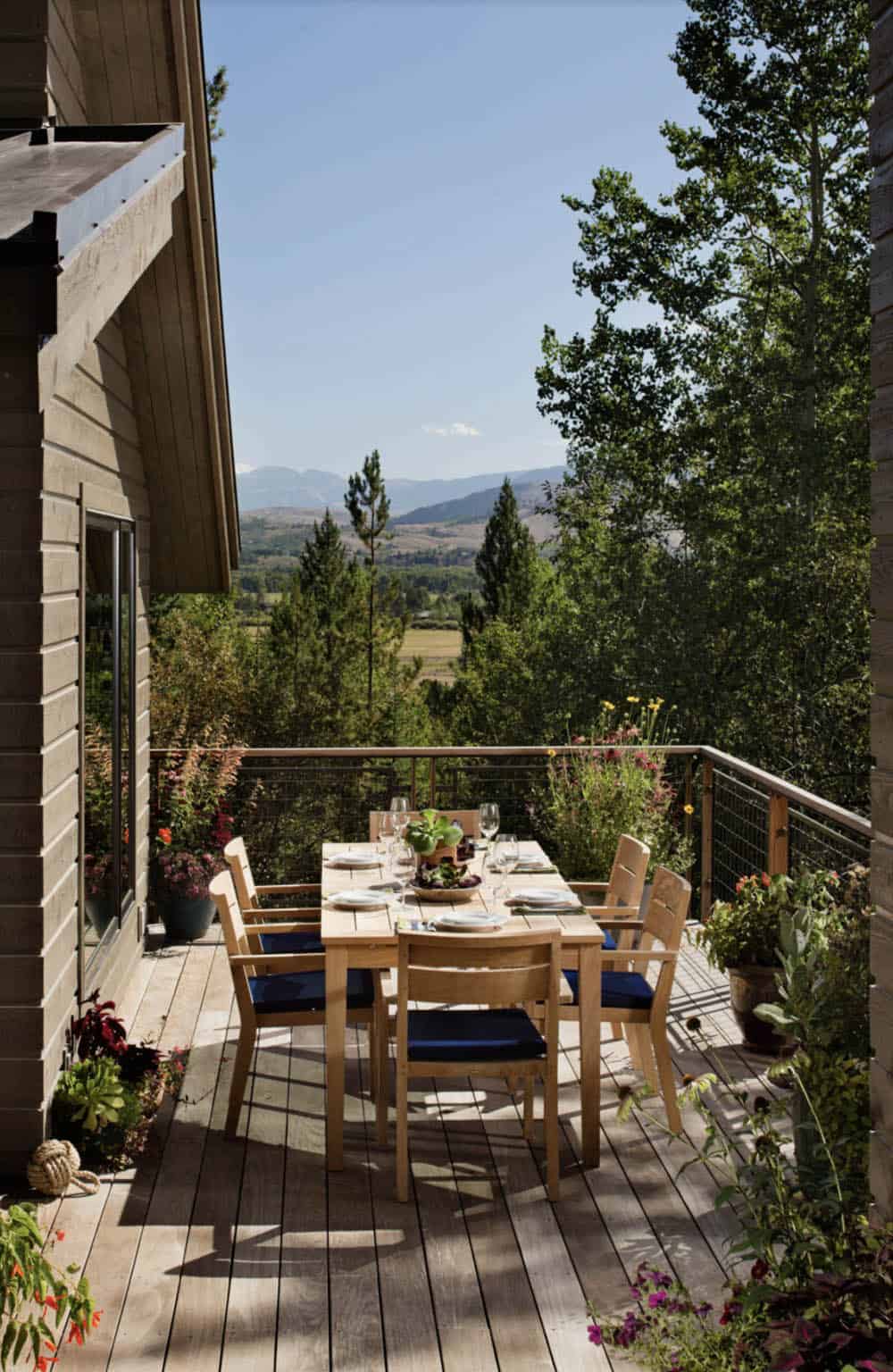 rustic deck with a dining table and chairs