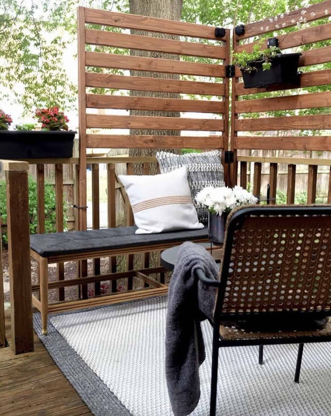 cozy corner deck with outdoor seating and slat privacy wall
