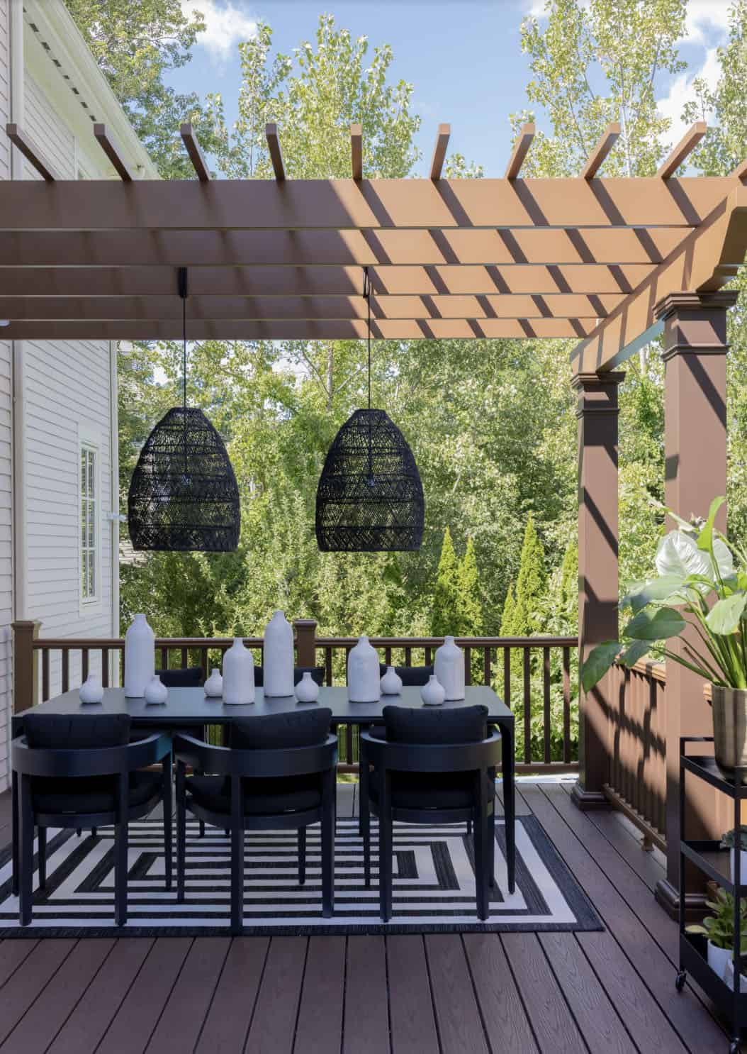 contemporary deck with a pergola and outdoor dining set