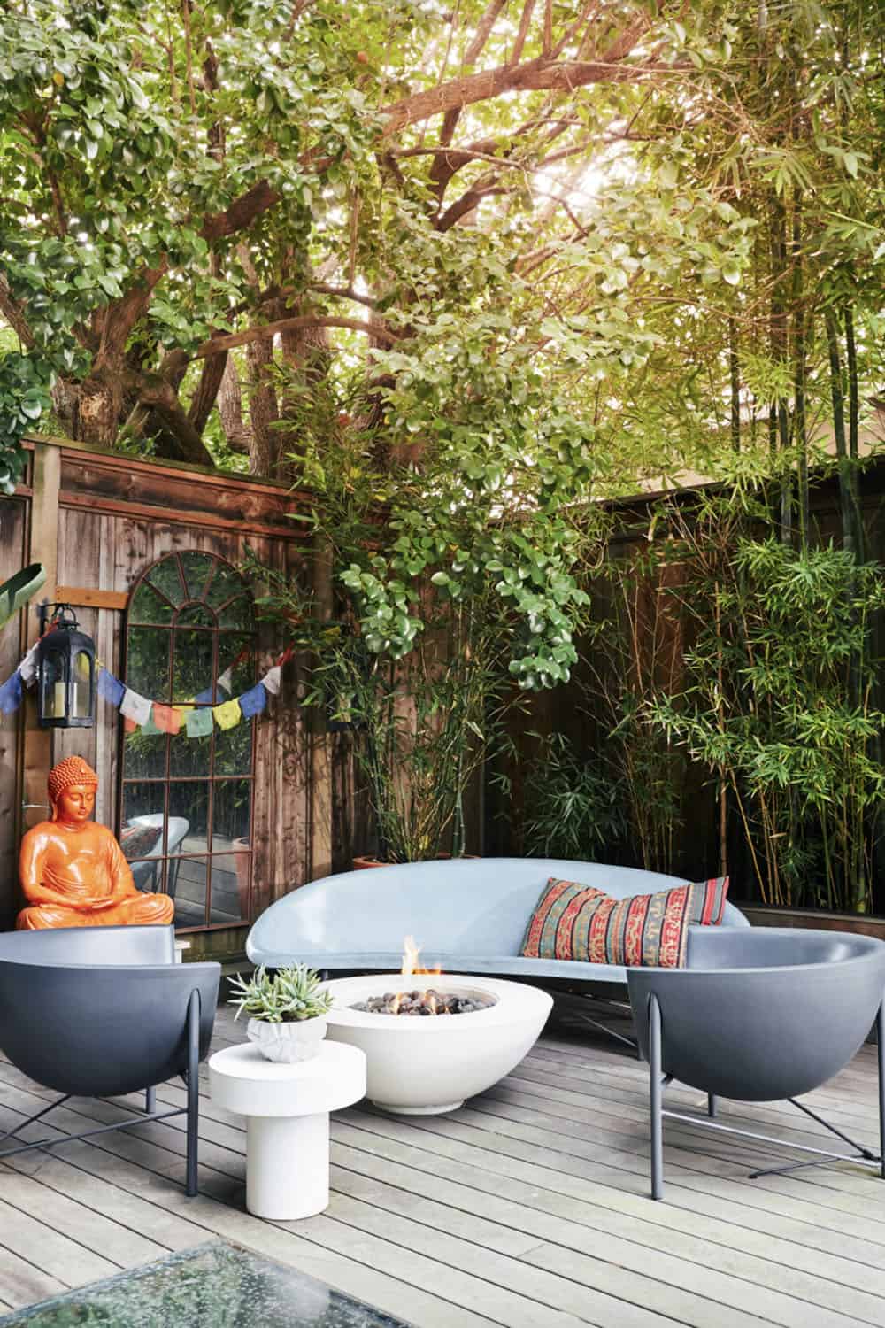 backyard deck with outdoor furniture, a fire pit and a mirror