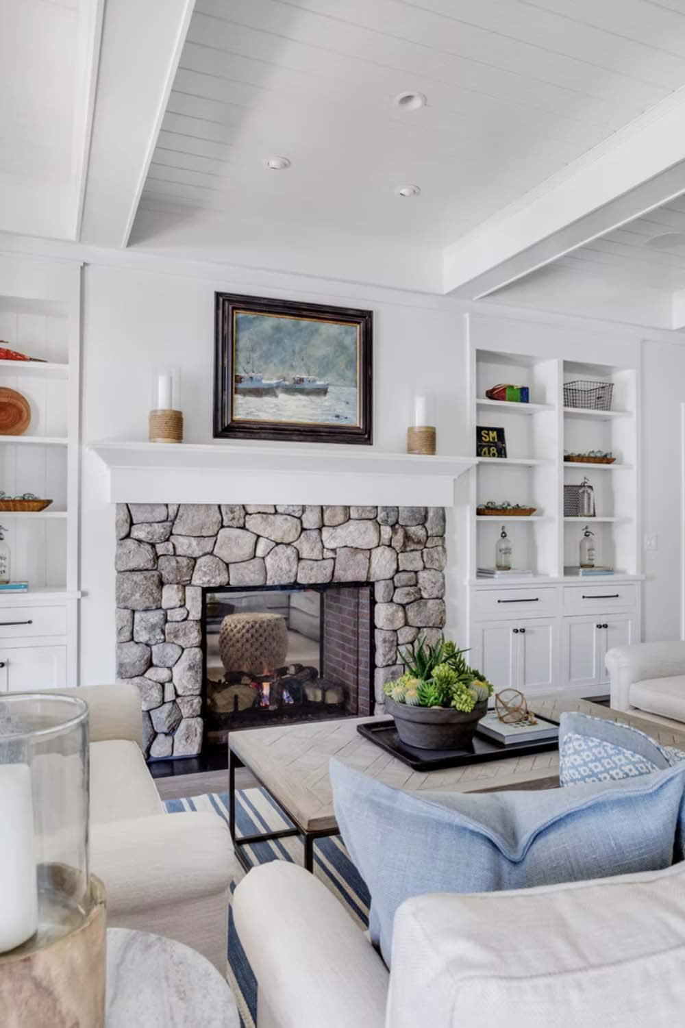 coastal style living room with a fireplace
