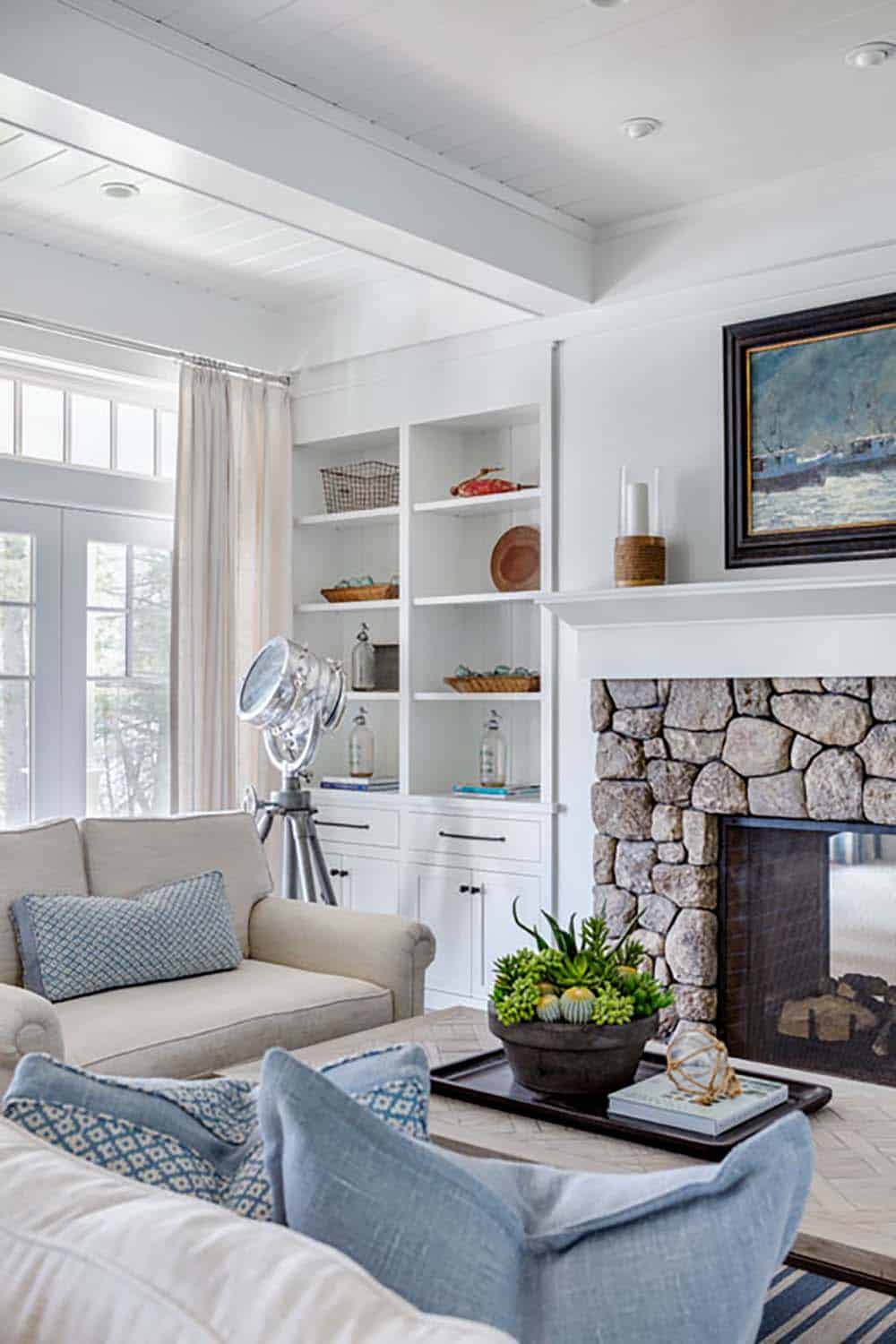 coastal style living room with a fireplace