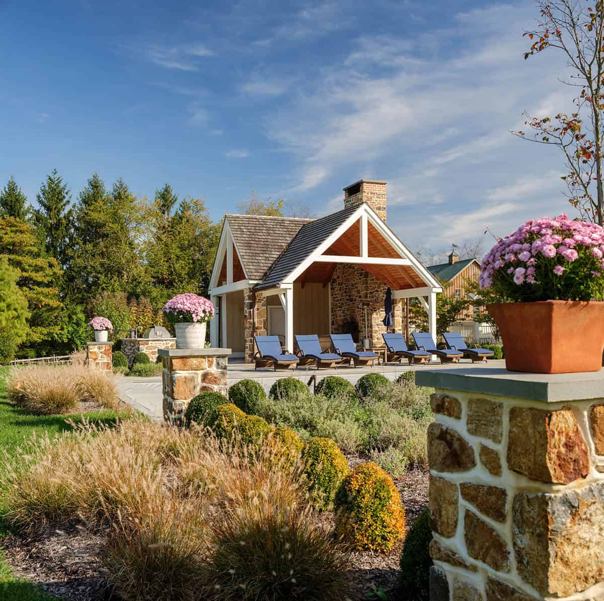 stone farmhouse home exterior backyard view