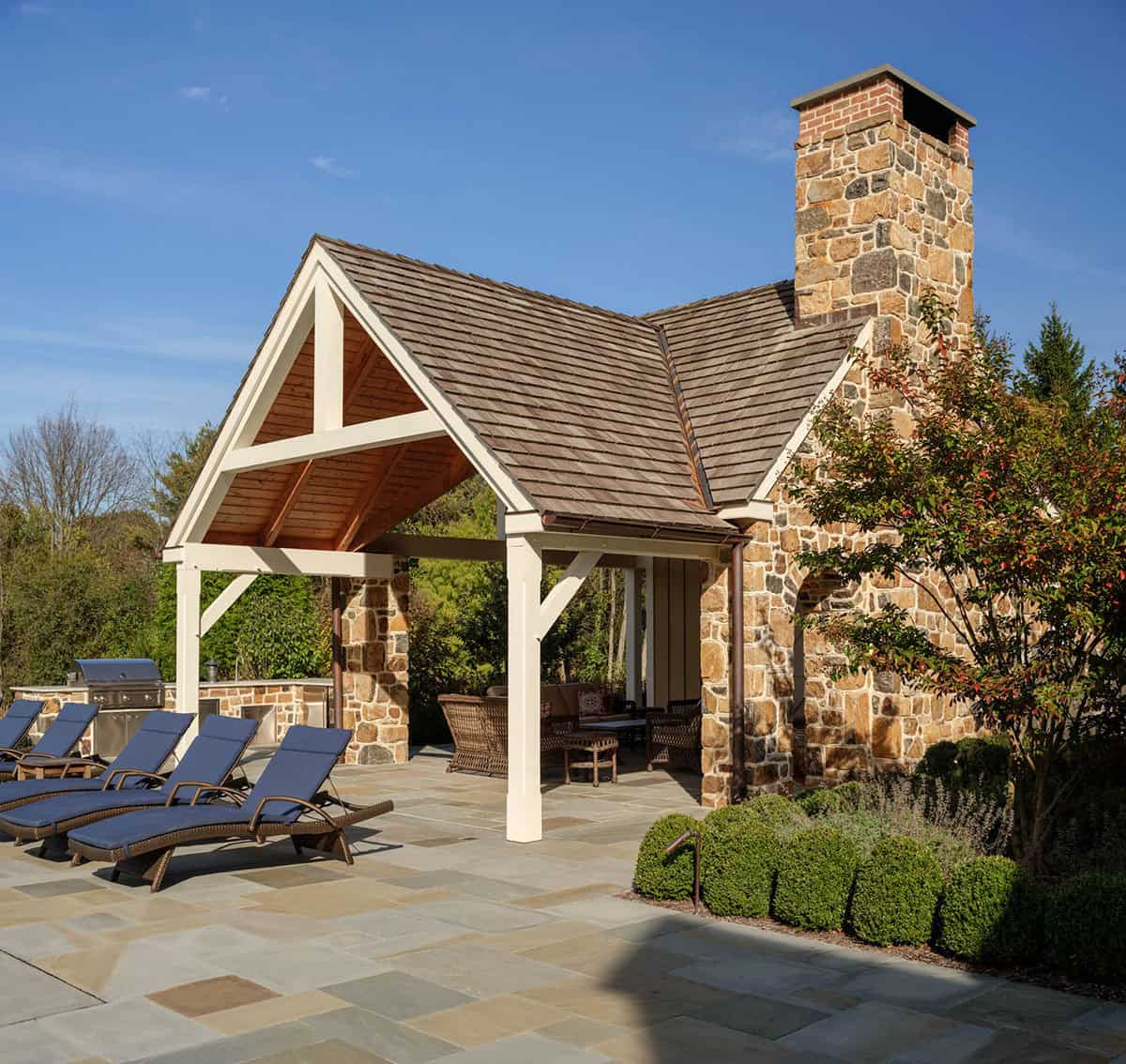 stone farmhouse home exterior backyard view