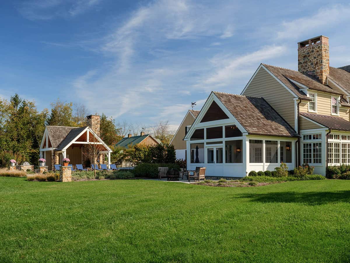 stone farmhouse home exterior backyard view