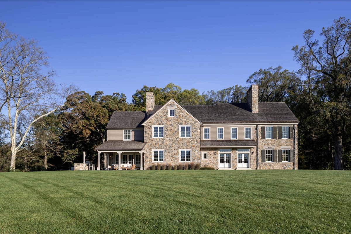 stone farmhouse style house exterior backyard view