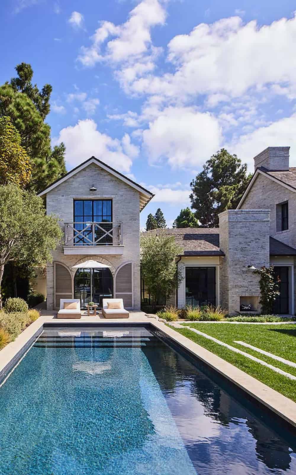 transitiional style home exterior with a pool