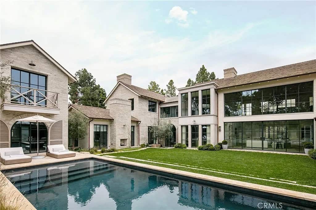 transitiional style home exterior with a pool