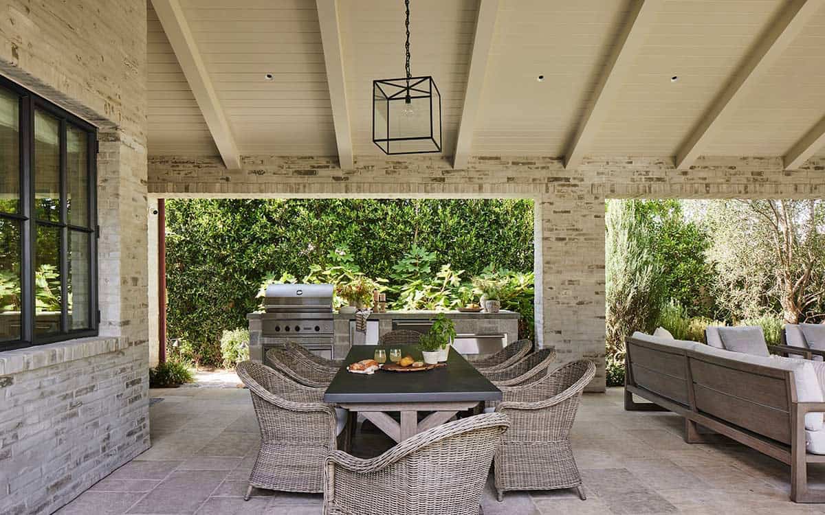 transitiional style home exterior with a covered patio and outdoor furniture