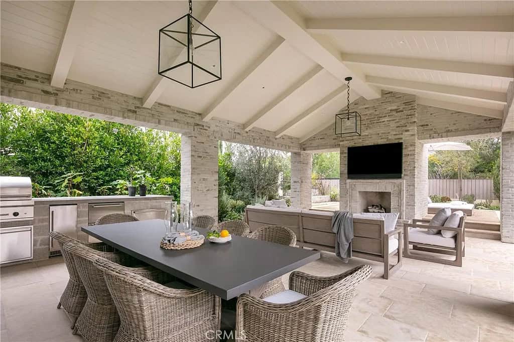 transitiional style home exterior with a covered patio and outdoor furniture