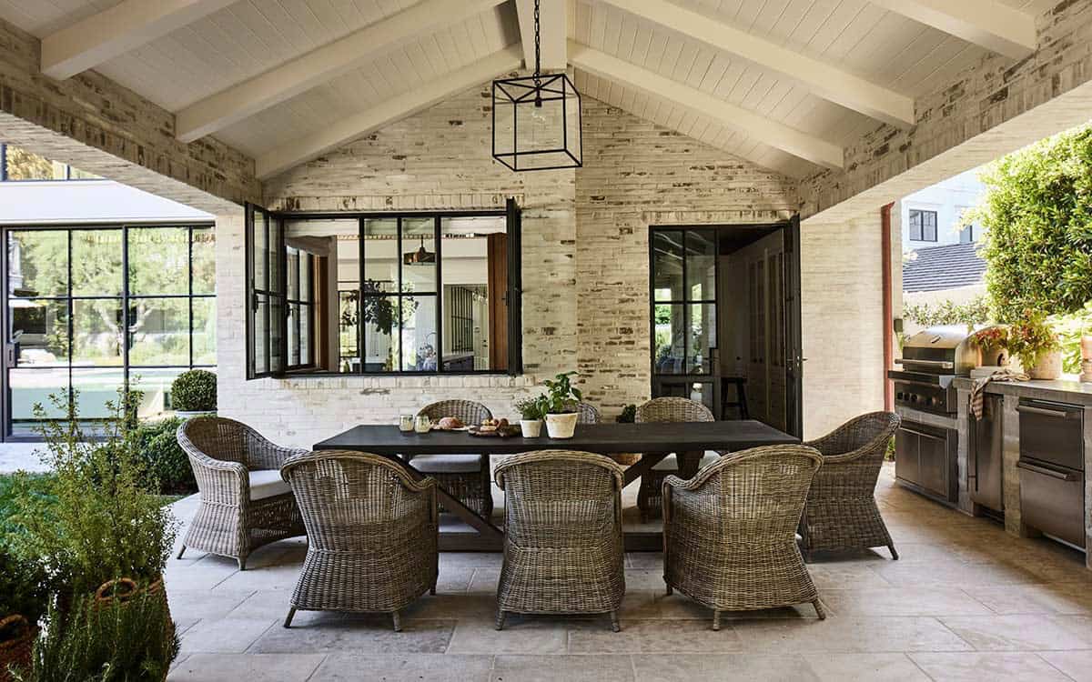 transitiional style home exterior with a covered patio and outdoor furniture