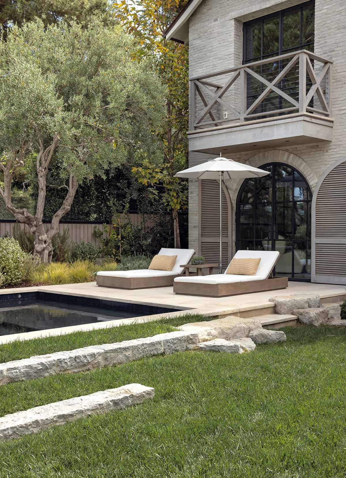 transitiional style home landscaping with a pool