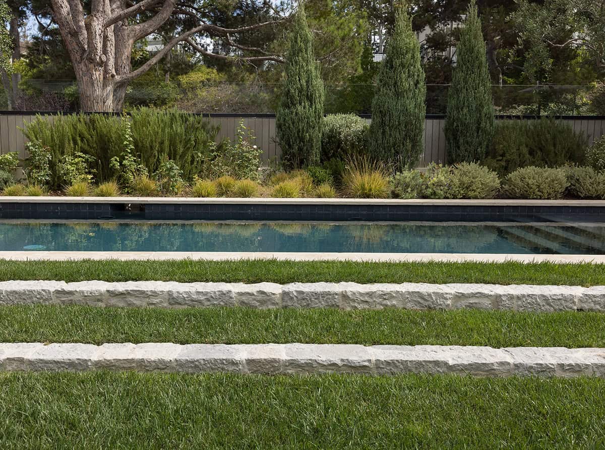 transitiional style home landscaping with a pool